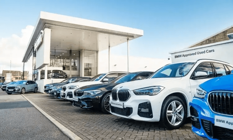 Luxury cars parked outside a modern dealership